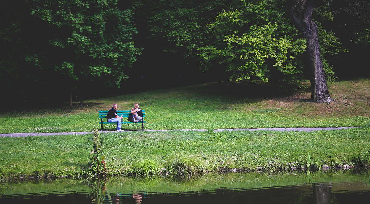 Assertive Message. An image showing two couple sitting in a bench while watching the lake