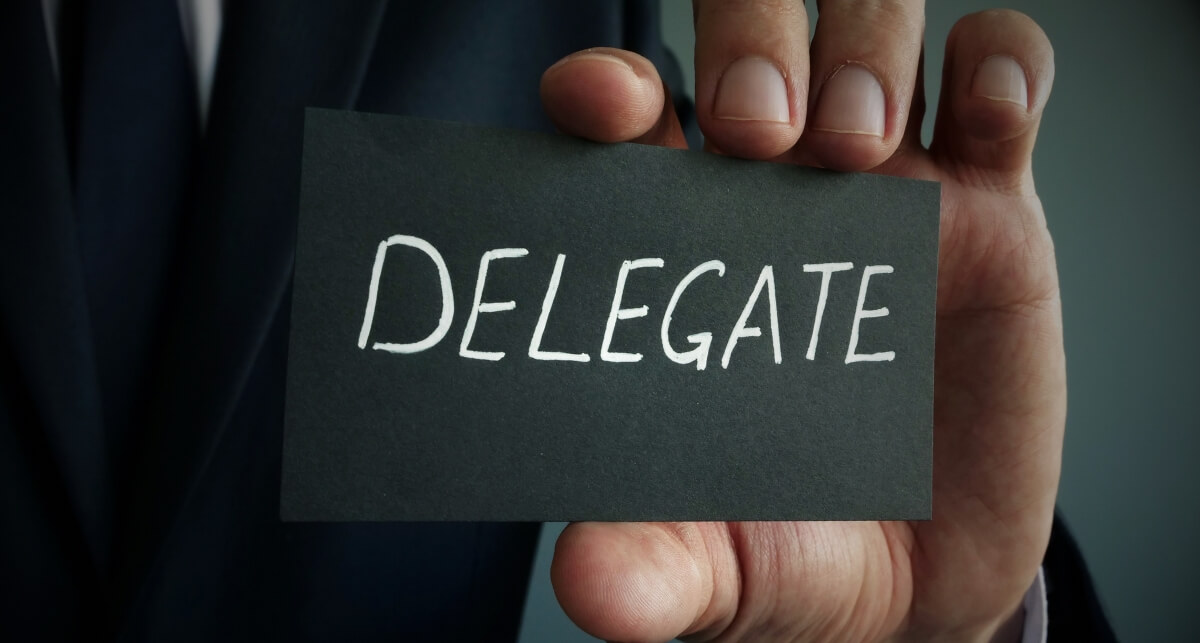 business card that says "Delegate"